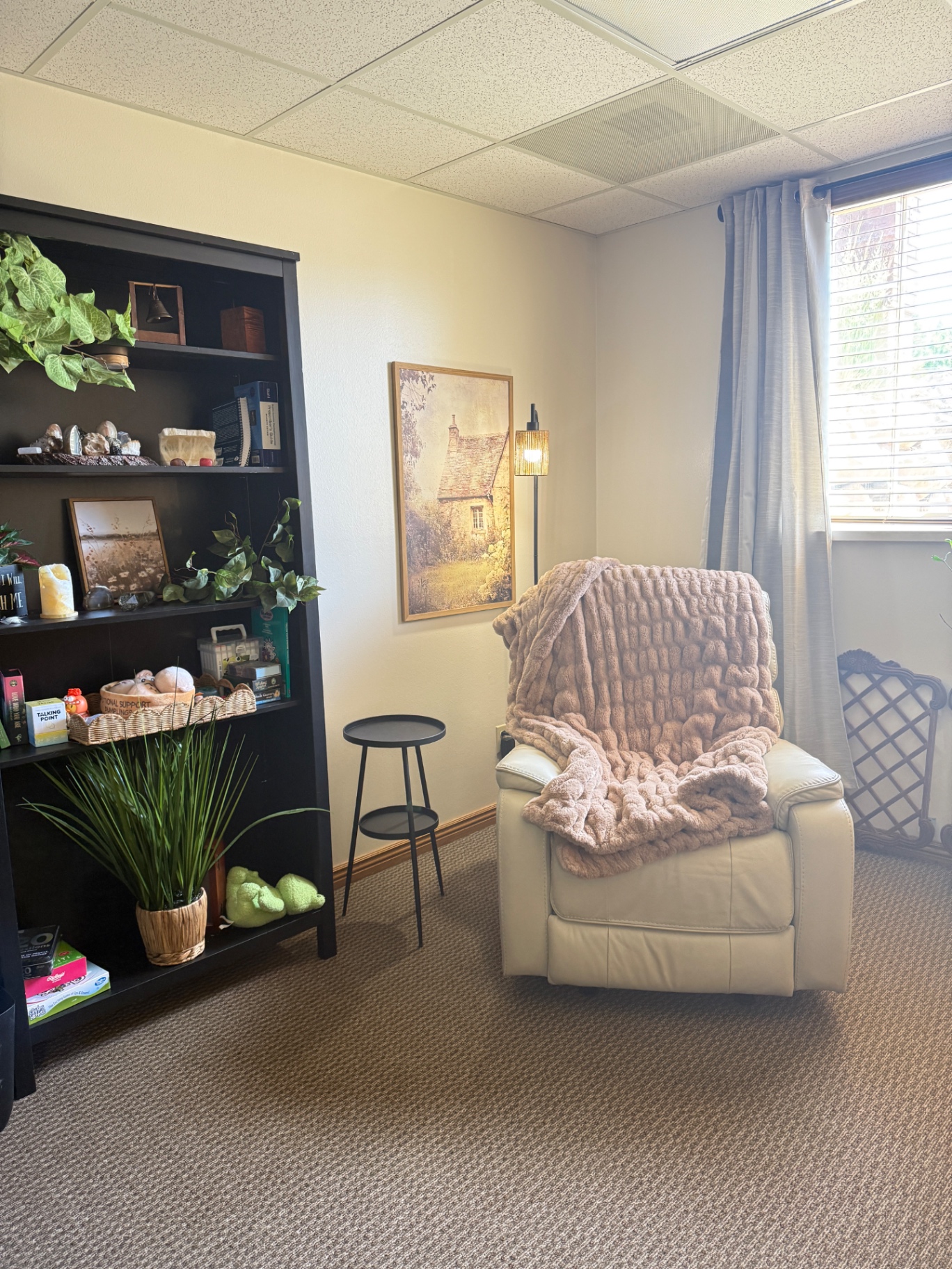 Michelle's office at Thrive Space — warm, plant-filled therapy room